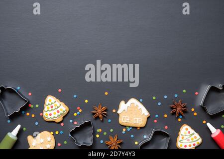 Forms for cooking and christmas cookies on black background with copy space Stock Photo