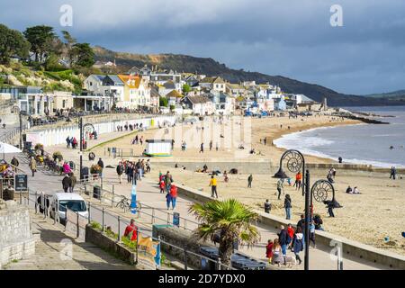 Lyme Regis, Dorset, UK. 26th Oct, 2020. UK Weather: Families and staycationers enjoy lovely warm sunny spells at the seaside resort of Lyme Regis during the half term holidays. Rain and wind is forecast for the rest of the week. Credit: Celia McMahon/Alamy Live News Stock Photo
