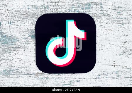 Kiev, Ukraine - August 25, 2020: TikTok icon printed on paper and put on modern wooden background. TikTok is a video-sharing social networking service Stock Photo