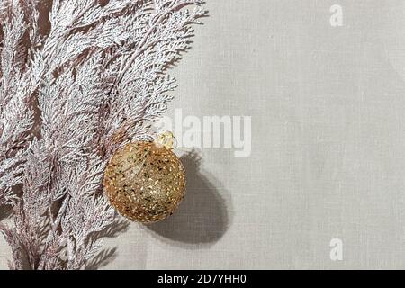 New Year's composition. Christmas decoration balls near a green branch of cypress on a linen cloth. Stock Photo