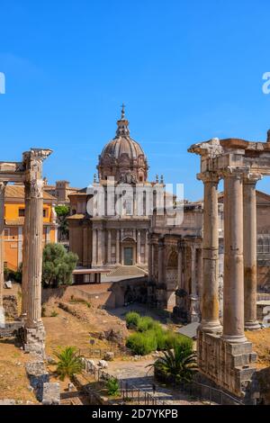 Ancient city of Rome in Italy, Roman Forum, Septimius Severus Arch and Santi Luca e Martina Church Stock Photo