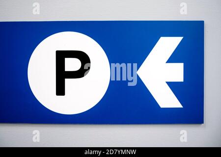 Blue parking sign with white arrow and black capital P on white background. Stock Photo