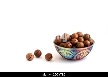 macadamia nuts in bowl on white background, copy space Stock Photo