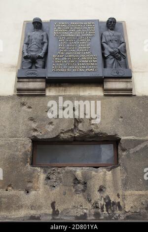 Commemorative plaque devoted to Czechoslovak paratroopers and Orthodox clergymen over the window to the crypt of the Cathedral of Saints Cyril and Methodius in Resslova Street in Nové Město (New Town) in Prague, Czech Republic. The plaque designed by Czech sculptor František Bělský was unveiled in 1947 in honour of Czechoslovak paratroopers fallen during the Operation Anthropoid as well of executed clergymen of the Czechoslovak Orthodox Church who offered refuge for the paratroopers in the crypt of the cathedral in 1942. Stock Photo