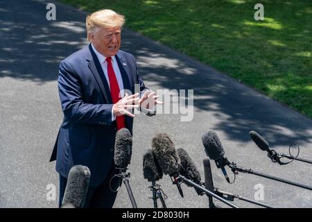 U.S. President Donald Trump speaks with reporters on the South Lawn prior to departing the White House aboard Marine One on June 26, 2019 in Washington,D.C.. Trump will travel to Japan to attend the G-20 Summit. Credit: Alex Edelman/The Photo Access Stock Photo