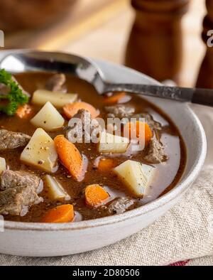 Closeup of a bowl of vegetable beef soup with carrots and potatoes Stock Photo