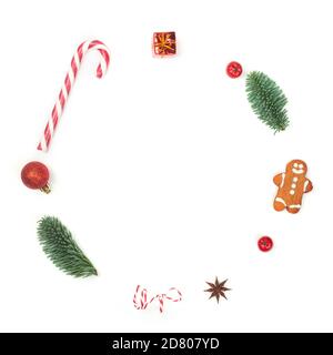 Christmas decorative minimalistic conceptual wreath with noble fir tree twigs and baubles objects design top view isolated on white background. New Ye Stock Photo