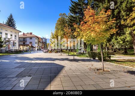 Razlog, Bulgaria - October 20, 2020: Downtown street panoramic view with autumn trees and people Stock Photo