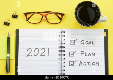 2021 goals written on a diary on multicolored background Stock Photo
