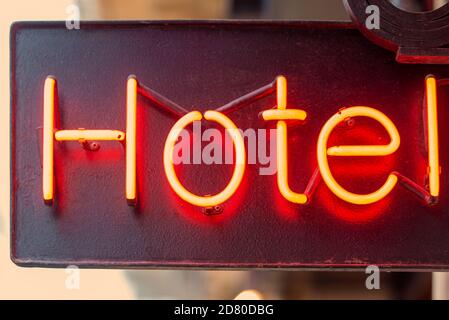 HOTEL neon red sign, hotel sign illuminated in the evening Stock Photo