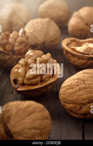 Walnuts in shell on a wooden background and empty space for text Stock Photo