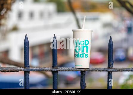 McDonald's fast food paper cup litter/ trash / rubbish on an iron fence in Southampton, England, UK Stock Photo