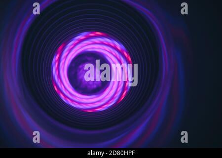 Abstract swirl tunnel with purple light on a background pattern textured for design. Stock Photo