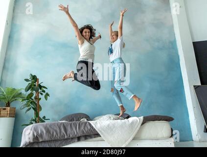 Two friends having fun in the bedroom on the bed. Stock Photo