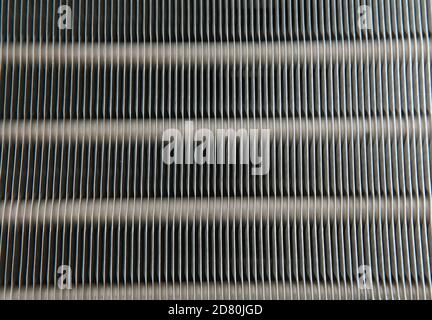 An air conditioner's evaporator coil, also called the evaporator core, is the part of the system where the refrigerant absorbs heat. Stock Photo
