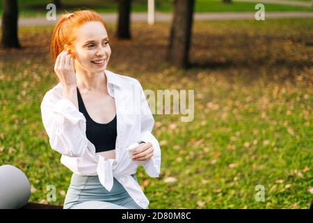 Close-up view of unrecognizable young woman tying shoelaces on sneakers before running. Stock Photo