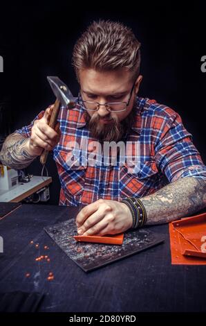 Craftsman working with leather working as artisan Stock Photo