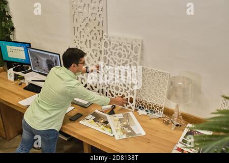 designer shows his design work by placing it on his desk Stock Photo