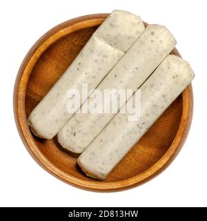Vegetarian barbecue sausages in a wooden bowl. Meatless white sausages made from egg and milk protein as a meat substitute, with herbs and spices. Stock Photo