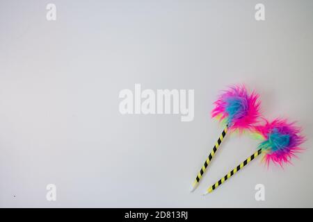 Two rainbow fluff pens on white background Stock Photo