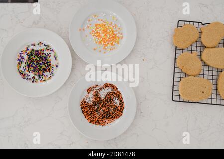 sprinkles for decorating holiday cookies on white counter Stock Photo