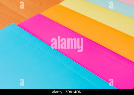 Collection of multi colorful papers lying on the table. Stock Photo