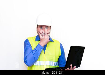 Attractive caucasian Technician Holding Laptop Over White Background.Makes gestures Stock Photo