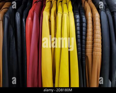 Collection of colorful leather jackets in a row Stock Photo