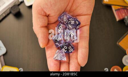 A hand holding a set of dices ready to throw  | flat lay Stock Photo