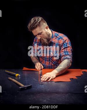 Currier manufacturing new leather product Stock Photo