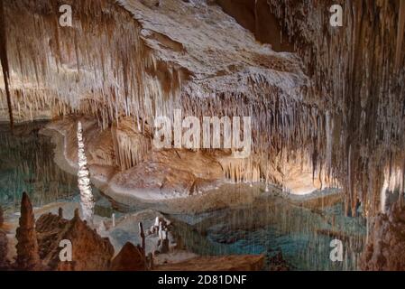 Flooded limestone cave interior with many stalactites and stalagmites and  reflections in the water surface, Drach caves / Cuevas del Drach, Mallorca. Stock Photo
