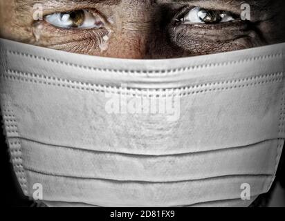 tearful man in a mask on his face Stock Photo
