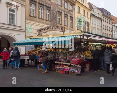 Prague, Czech Republic, December 12, 2019: Tourist people shopping at traditional christmas Market, Havelska trznice street with stalls selling gifts, Stock Photo