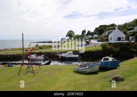 A small boat haven and swing park in the village of Corrie on the Isle of Arran, Scotland, Uk. Stock Photo