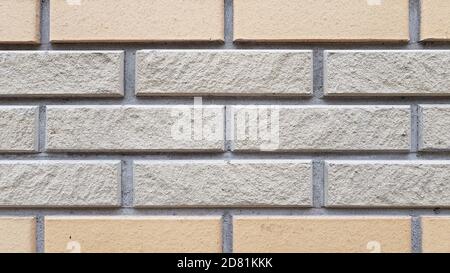 Two types of rectangular brick tiled wall. Brick pattern textured background. Brickwork backdrop. Stone masonry wall surface closeup Stock Photo