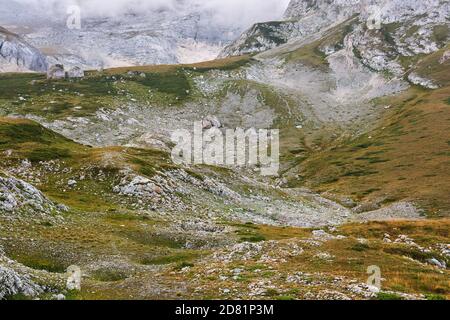 mountain valley with alpine tundra and weathered cobblestone fields near the snow line in the Caucasus Stock Photo