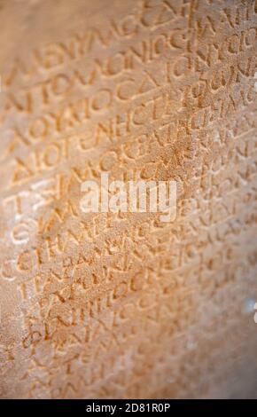 Fragment of the ancient greek letters carved on the stone Stock Photo