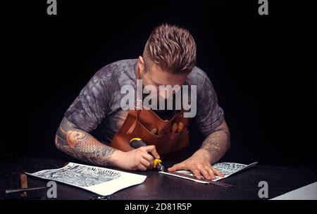 Professional Tanner creates a new leatherwork Stock Photo