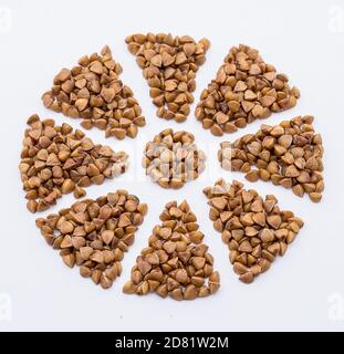 buckwheat porridge, buckwheat on a white background, snowflake from buckwheat grains, flower from cereals Stock Photo