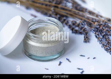 Natural handmade cosmetic cream jar and dried lavender flowers, light blue background. Bio organic cosmetics, aromatherapy concept Stock Photo