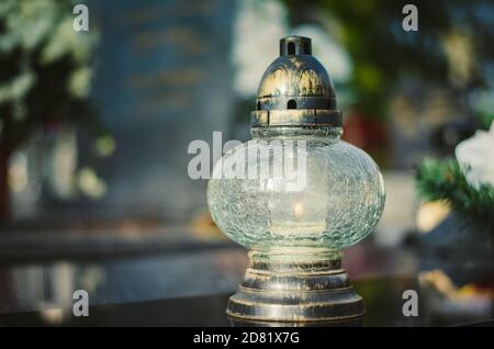 candle burning in lantern during All Saints Day Stock Photo