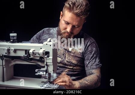 Craftsman working with leather forms new leather product in workshop Stock Photo