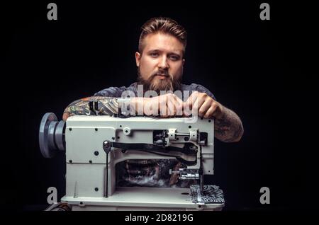 Artist working with leather creates a new leather product at his tanning shop Stock Photo