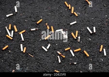 cigarette butts discarded on street Stock Photo