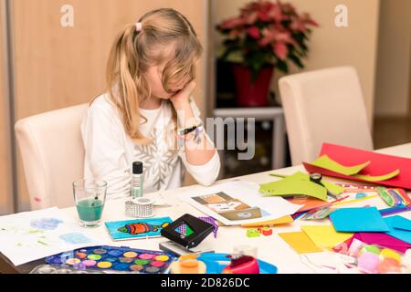 adorable blond girl making christmas card for friends and relatives Stock Photo