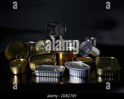 Different types of cans with prepared foods for consumption, vegetables, fish and meat Stock Photo