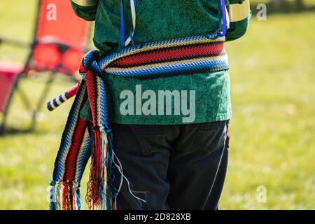 Selective focus of waist of young performer standing dress in colorful clothing costume with waistband in cultural fiesta during performance Stock Photo