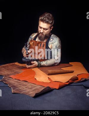 Leather Artisan works with leatherwork Stock Photo