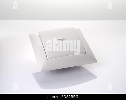 White glossy light regulator on a light background. Stock Photo