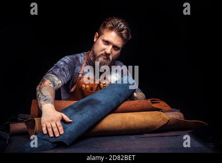 Worker of leather creating a new leather product Stock Photo